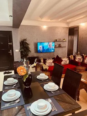 a living room with a table and a couch at Luxury apartments 3 in Casablanca
