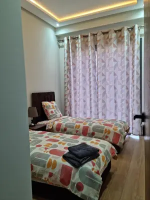 a bedroom with a bed and a window at Appartement - Dar Bouazza spacieux avec piscine à Dar Bouazza in Dar Bouazza