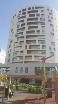 a tall apartment building with a large building at Casablanca Marina by Saloua in Casablanca