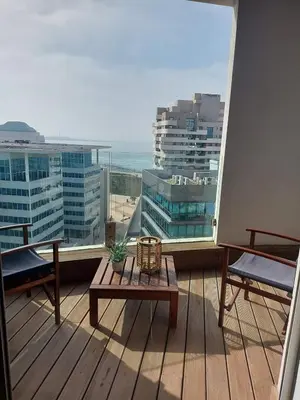 a balcony with a table and benches on a building at Casablanca Marina by Saloua in Casablanca