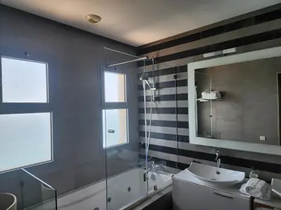 a bathroom with a shower and a sink and a tub at Casablanca Marina by Saloua in Casablanca