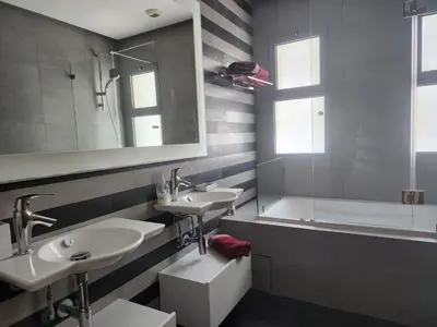 a bathroom with two sinks and a bath tub at Casablanca Marina by Saloua in Casablanca