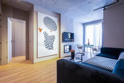 a living room with a blue couch and a painting at TWENTY SIX ANFA LUXURY RESIDENCE by Shortstaymaroc -Hyper Centre -Parking in Casablanca