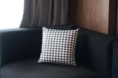 a pillow is sitting on a blue couch at TWENTY SIX ANFA LUXURY RESIDENCE by Shortstaymaroc -Hyper Centre -Parking in Casablanca