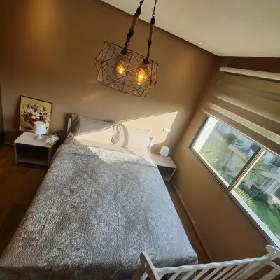 a bedroom with a bed and a window at Sidi Rahal Bleu Beach family in Sidi Rahal