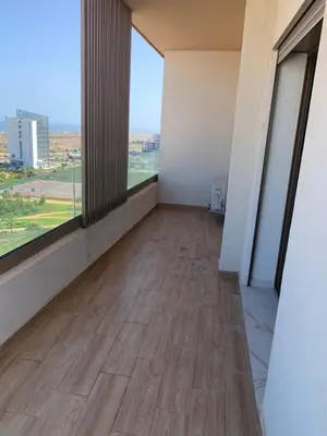 an empty room with a hard wood floor and large windows at Zenata Tower in Casablanca