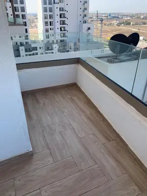 a room with a hard wood floor and a window at Zenata Tower in Casablanca