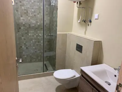 a bathroom with a shower and a toilet and a sink at Zenata Tower in Casablanca