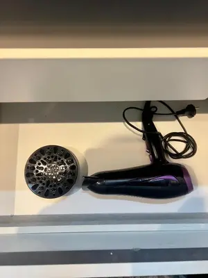 a hair dryer and a brush sitting on a microwave at Best location, 2 minute to beach in Casablanca