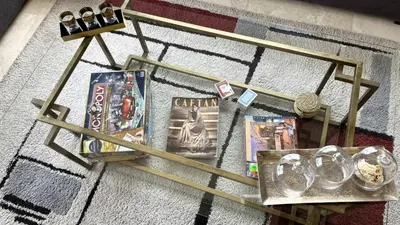 a wooden table with games and magazines on it at Nouaceur Garden in Casablanca