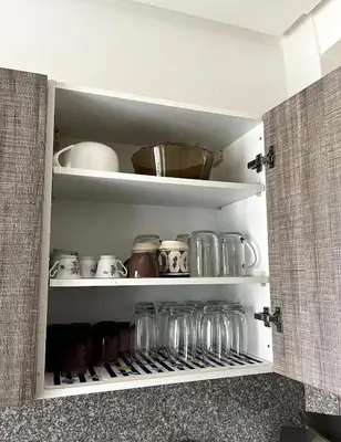 a kitchen pantry with jars and dishes on shelves at Nouaceur Garden in Casablanca