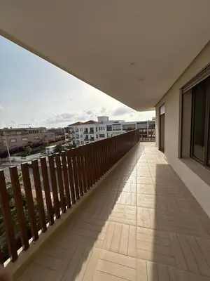 a balcony with a view of a city at North Beach Plage & Confort in Mansouria