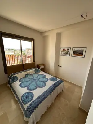 a bedroom with a bed and a window at North Beach Plage & Confort in Mansouria
