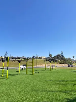 a field with yellow poles in the grass at Maison du bonheur in El Harhoura