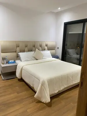 a bedroom with a large white bed in it at Prestigia Appartement Luxueux in Rabat