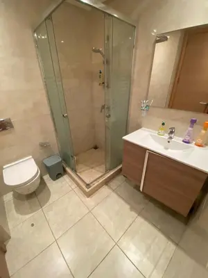 a bathroom with a shower and a sink and a toilet at Prestigia Appartement Luxueux in Rabat