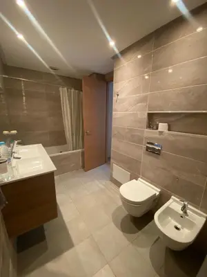a bathroom with a toilet and a sink and a tub at Prestigia Appartement Luxueux in Rabat