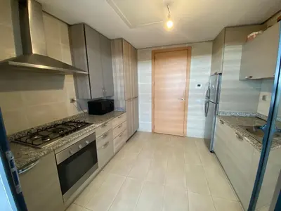 a kitchen with a stove and a stove top oven at Prestigia Appartement Luxueux in Rabat