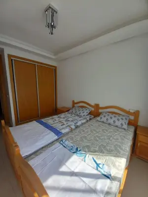 a bedroom with two twin beds in a room at Bel Appartement à Mansbay in Mansouria