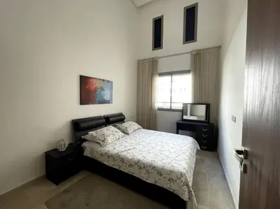 a bedroom with a bed and a television in it at Luxury apartment 5 minutes Casablanca Airport in Nouaceur