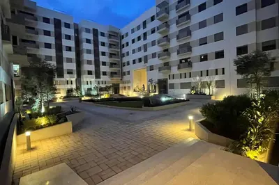 an empty courtyard in a apartment building at night at Luxury apartment 5 minutes Casablanca Airport in Nouaceur
