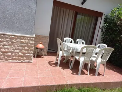 a table and chairs sitting on a patio at Ilyass Garden Beach Sidi Rahal in Dar Hamida
