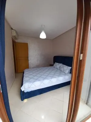 a small bedroom with a bed in a room at Ilyass Garden Beach Sidi Rahal in Dar Hamida