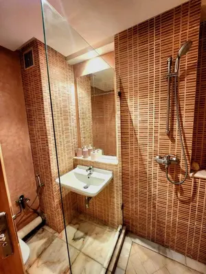 a bathroom with a sink and a shower at La perle in Nouaceur