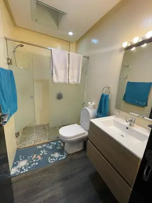 a bathroom with a toilet and a sink and a shower at BEAU TRIPLEX EN RESIDENCE in Skhirat