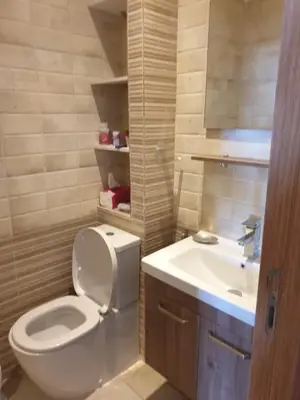 a bathroom with a toilet and a sink at Luxueux appartement front mer in Sidi Rahal