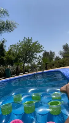 a swimming pool filled with blue and green glasses at Villa avec piscine et jardin privés in Casablanca