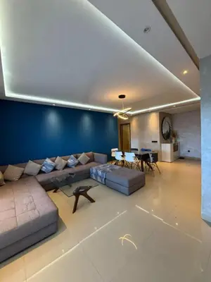 a large living room with a couch and a table at Appartement meublé piscine Residence eden tamaris in Dar Bouazza