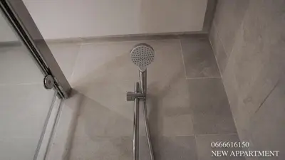 a shower with a shower head in a bathroom at New prestigia in Rabat