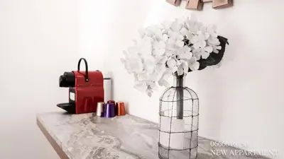 a vase filled with white flowers sitting on a table at New prestigia in Rabat