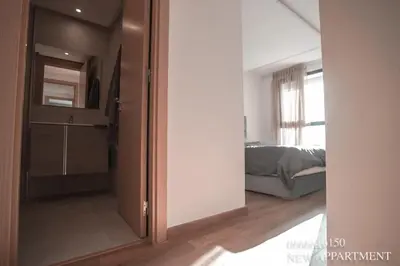 a sliding door leading to a bedroom with a bed at New prestigia in Rabat