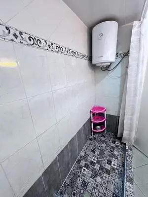 a bathroom with a pink stool in a shower at Casablanca Beautiful and Tranquil Family Apartment in Casablanca