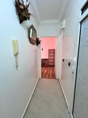 a hallway with a phone on the wall at Casablanca Beautiful and Tranquil Family Apartment in Casablanca