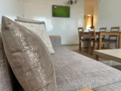 a couch with two pillows in a living room at Casablanca Beautiful and Tranquil Family Apartment in Casablanca