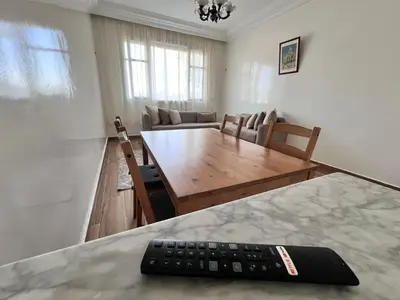 a remote control sitting on a table in a living room at Casablanca Beautiful and Tranquil Family Apartment in Casablanca