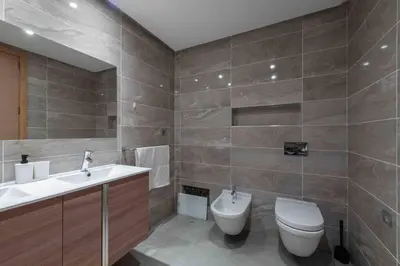 a bathroom with a toilet and a sink at Très bel appartement bien situé Hayriad in Rabat