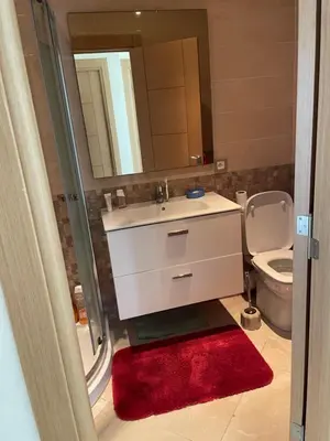 a bathroom with a sink and a toilet and a mirror at Appartement à Casabay SidiRahal in Sidi Rahal