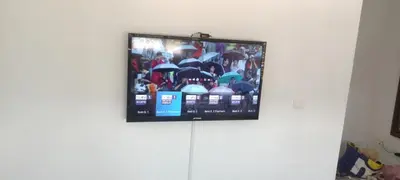 a flat screen tv hanging on a wall at perle de bouznika 15min walking to the beach plus free unlimited WiFi in Bouznika
