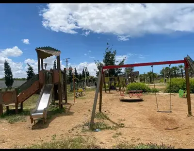 a playground with a slide and a swing set at perle de bouznika 15min walking to the beach plus free unlimited WiFi in Bouznika