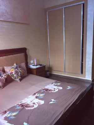 a bedroom with a large bed with a window at Sweet Room Airport 5 in Deroua