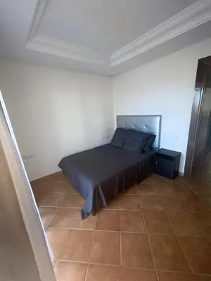 a bedroom with a bed and a tiled floor at BOUZNIKA BAY COUNTRY CLUB in Bouznika