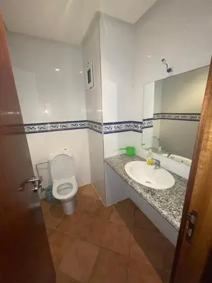 a bathroom with a toilet and a sink at BOUZNIKA BAY COUNTRY CLUB in Bouznika