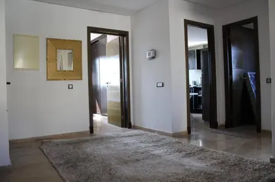 a hallway with two doors and a rug at Appt 22 Bloc G- Hicherraton plage Residence Bella Vista, BOUZNIKA BAY in Skhirat