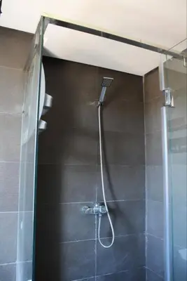 a shower with a glass door in a bathroom at Appt 22 Bloc G- Hicherraton plage Residence Bella Vista, BOUZNIKA BAY in Skhirat