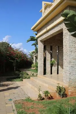 a brick building with a staircase in front of it at Appt 22 Bloc G- Hicherraton plage Residence Bella Vista, BOUZNIKA BAY in Skhirat