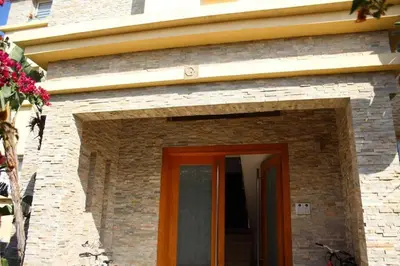 a brick building with a red door on it at Appt 22 Bloc G- Hicherraton plage Residence Bella Vista, BOUZNIKA BAY in Skhirat